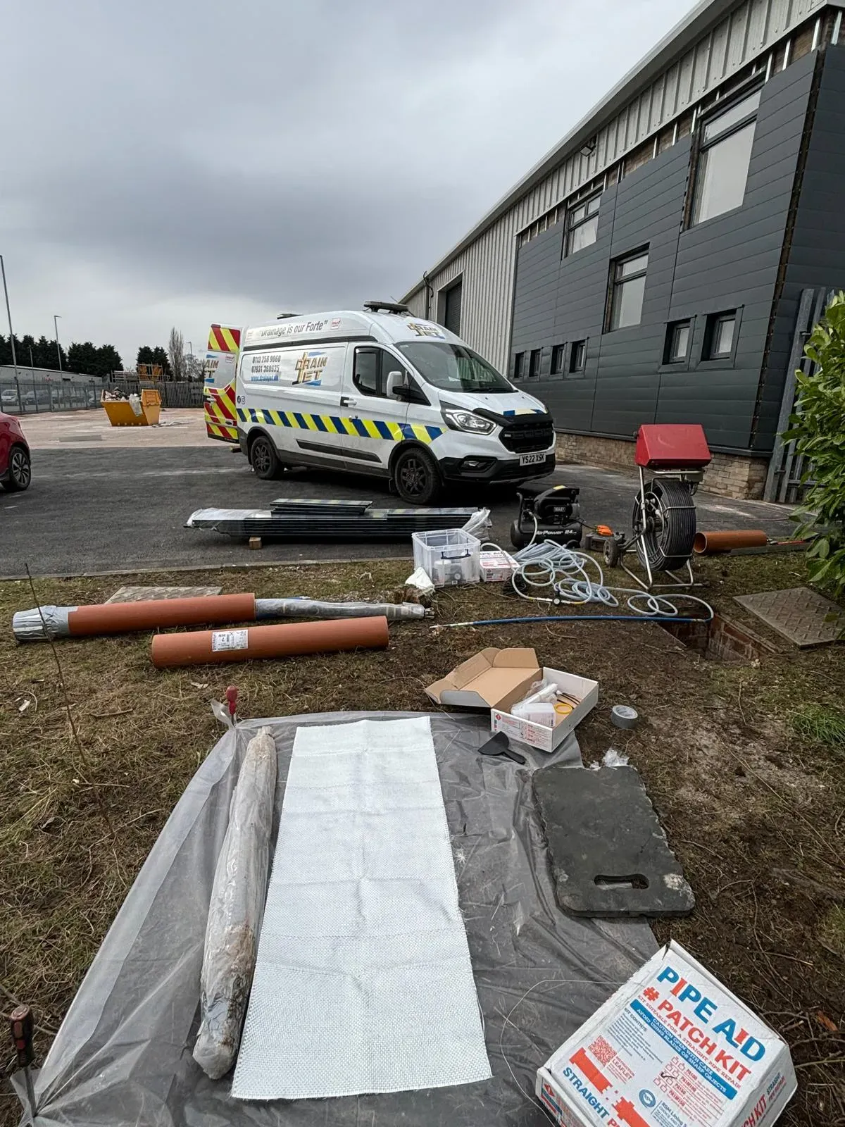 No-dig patch repair equipment and Drain Jet service van at a commercial property in Leeds.